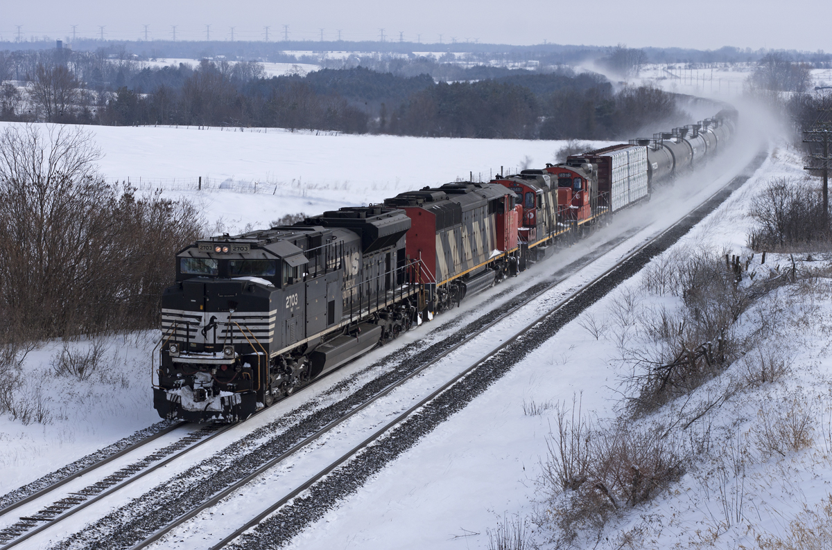 NS 2703 leads CN train 373 through Newtonville after a fresh snowfall. Headlights were dimmed as they were about L350.