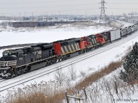 The first of what would become a number of good catches this day, NS 2703 leads CN 5556, 4141, and 4018 on 373's train through the grand curve at Whitby. One marvels at the luck involved in catching an NS leader with a 60F and two GP9's trailing, and I tip my hat to the power planners. For those wondering, the geeps aren't strictly along for the rid as the 4018 was working as they passed by Beare on the grade up the York Sub. 0946hrs.