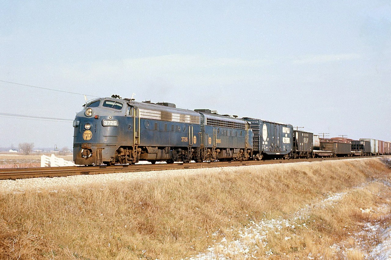 A nice back-to-back A-A set of matching F-units is always a treat: Norfolk and Western F7A's 3726 and 3666 pass by on the north main of CN's Chatham Sub at Thamesville Ontario, with a nice mixture of manifest freight in tow.