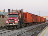 At the end of a long day, a OWS Railroad Construction and Maintenance Mack Granite hi-rail truck sits parked with a cut of 10 National Steel Car-built CN ballast hoppers on the Bramalea North Service Track by the GO station. Some still bear their "Government of Canada, Branchline Rehabilitation Program" markings from the late 1970's, as the cars purchases were funded by the Government of Canada for both CN and CP to help upgrade aging prairie branchline infrastructure. The triple tracking of the CN's Halton Sub between Halwest and Norval would see the north service track here become the #1 main track, making the then-current north and south mains the #2 and #3 main tracks.
