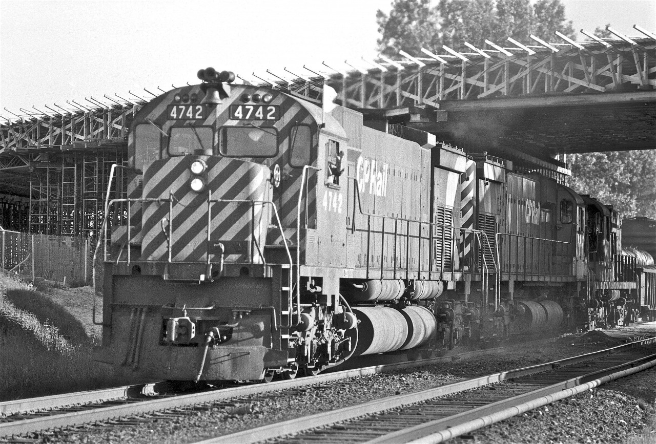 This is probably one of my first train photographs.  


I have no detailed information on this shot, but I’m thinking it may be around the summer of ’73… I would have been 12 at the time.  The overpass under construction is at Pharmacy Avenue, in Scarborough… a short walk from my childhood house.  I’m taking this picture from the temporary pedestrian crossing – it was a pretty cool place to watch trains up close and personal. My friends Doug, Chris, and Blair are helping by jumping up and down and acting like complete idiots (they were very good at it)… anything to get a wave from the crew and a friendly blast on the horn – once again, it looks like their efforts were successful!


MLW #4742 (M-636) would have been just a few years old, having been manufactured in November 1970.  She was a Class DRF-36c.  Internet research shows her retirement in 11/93.  She was un-retired the following April.  Serious retirement took place in August ’95.