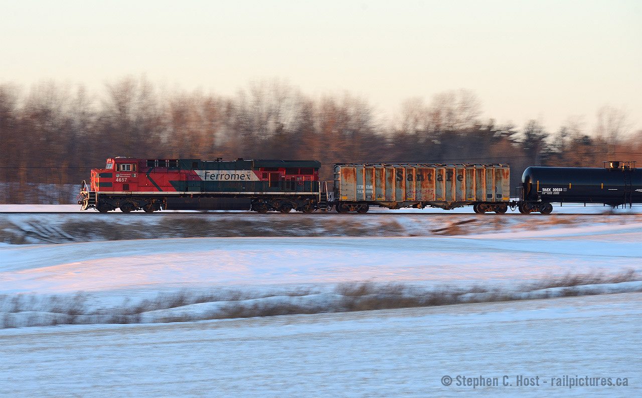 In the last rays of sun, a far from home Ferromex engine is pushing on the tail end of Oil Train 550. Leader for this train was CP 8519 and, as expected, this train was not making track speed with 100 oil cans and two buffers.