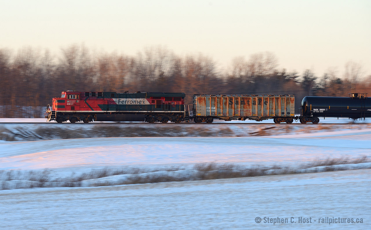 In the last rays of sun, a far from home Ferromex engine is pushing on the tail end of Oil Train 550. Leader for this train was CP 8519 and, as expected, this train was not making track speed with 100 oil cans and two buffers.