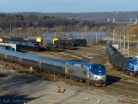 <b>Sometimes you get lucky</b> is a recurring theme for me - on the 31st of December 2014 I found myself on forced vacation due to plant shutdown at work, a sunny morning, and a few hours to kill before I tend to other matters. Why not get some photos. So I headed to the Bayview area to start with Amtrak and SOR<br><br>To the layperson from California or in the greater USA, this scene could be anywhere Amtrak runs with a small yard. But if you look closely by the York Rd Bridge you'll see some familiar zebra stripes. We're at CN/SOR Stuart St yard in Hamilton, VIA 97 is passing the SOR yard job switching cars, and CN 550 is rescuing 555 in the far distance. <br><br>By the time I took this photo it had been nearly 30 minutes since 555 was being rescued by 550 and it sounded like departure of 550 was imminent. I was very uncertain of my chances of getting somewhere to see or even photograph that action, but I was lucky. I was very lucky the morning of the 31'st of December 2014. <a href=http://www.railpictures.ca/?attachment_id=17918>Photo of 550/555 rescue</a><br>  <a href=http://www.railpictures.ca/?attachment_id=17549>30 minutes of action at Hamilton later that morning</a><br><br>A great way to end the year and an excellent use of a half day of forced vacation :) More luck from the 31st yet to come.. later though... :)