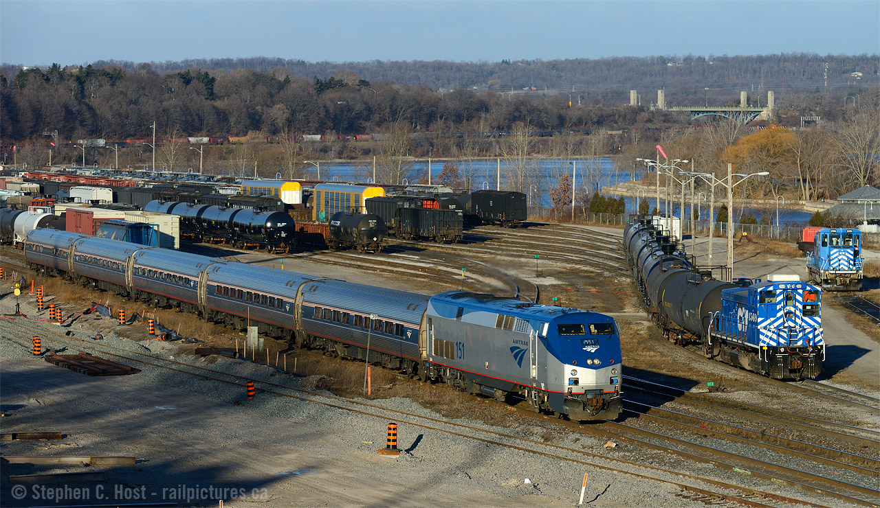 Sometimes you get lucky is a recurring theme for me - on the 31st of December 2014 I found myself on forced vacation due to plant shutdown at work, a sunny morning, and a few hours to kill before I tend to other matters. Why not get some photos. So I headed to the Bayview area to start with Amtrak and SOR

To the layperson from California or in the greater USA, this scene could be anywhere Amtrak runs with a small yard. But if you look closely by the York Rd Bridge you'll see some familiar zebra stripes. We're at CN/SOR Stuart St yard in Hamilton, VIA 97 is passing the SOR yard job switching cars, and CN 550 is rescuing 555 in the far distance. 
By the time I took this photo it had been nearly 30 minutes since 555 was being rescued by 550 and it sounded like departure of 550 was imminent. I was very uncertain of my chances of getting somewhere to see or even photograph that action, but I was lucky. I was very lucky the morning of the 31'st of December 2014. Photo of 550/555 rescue  30 minutes of action at Hamilton later that morning
A great way to end the year and an excellent use of a half day of forced vacation :) More to come later..