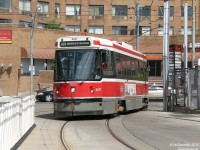 TTC CLRV 4017 swings into Dundas West Subway Station with a load of passengers, at the end of it's run along Dundas Street as a 505 car. In the background is The Crossways Mall and apartment tower complex, sitting on the site of the old Canada Bread plant. Before the Bloor-Danforth subway line opened, there used to be a loop in the background on the other side of Dundas where cars turned, called "Vincent Loop".