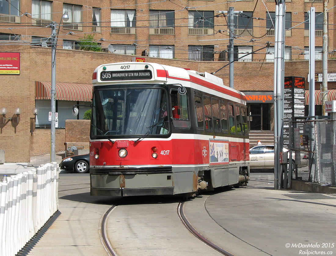 TTC CLRV 4017 swings into Dundas West Subway Station with a load of passengers, at the end of it's run along Dundas Street as a 505 car. In the background is The Crossways Mall and apartment tower complex, sitting on the site of the old Canada Bread plant. Before the Bloor-Danforth subway line opened, there used to be a loop in the background on the other side of Dundas where cars turned, called "Vincent Loop".
