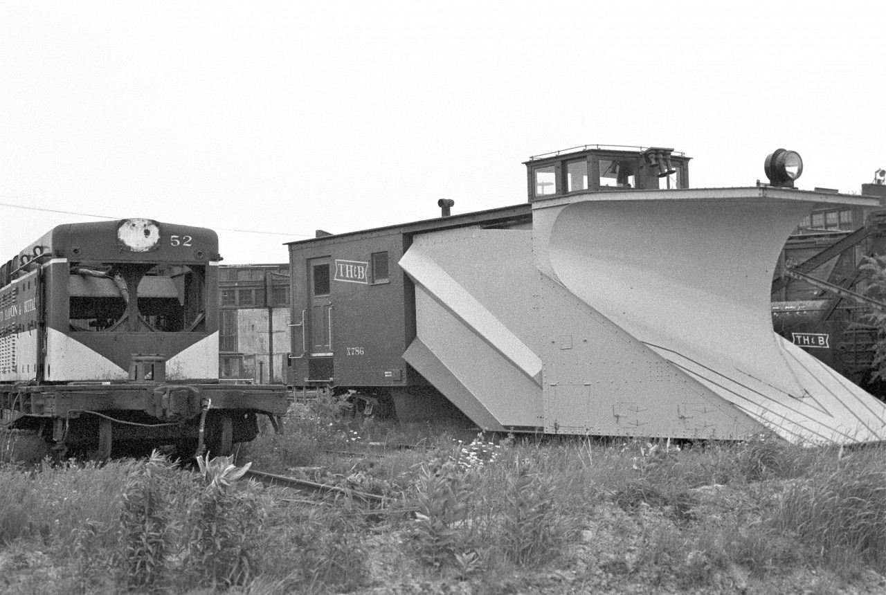 The carcass of #52 (GMD type NW-2) sits on Death Row near the Chatham Street roundhouse.  Internet research shows that she was built in January, 1948.  It wouldn’t be until 05/88 that she was sent to Atlas Steel in Welland to be scrapped. 


Meanwhile, the plow looks ready to do battle with the next blizzard.