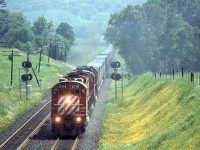 I'm standing on the horse bridge over the Galt Subdivision on a humid June morning in 1993 waiting to see what may come my way.

I didn't have to wait long as train 509 with three 4700's (4718,4735,4704) called the RTC for a clearance passing by the Glen Eden ski hill to continue it's journey west. The train rounded the curve a minute later and provided me with this amazing scene.

While this location has changed a little over the years gone are the 4700's and the Kodachrome I shot them on.