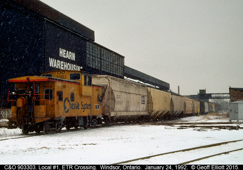 C&O caboose #903303 is bringing up the rear of Local #1 as it begins it's journey out of town and back to Chatham.  CSX GP38 #2003 has the point as they cross the ETR Diamond and two crew members, who seem to enjoy the cold, ride on the rear platform taking in the scenery as they trundle along the old C&O #1 Sub as trains had done for over 100 years before them.
