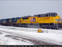 Union Pacific SD70AH #8972 led train 640-021 to Windsor, Ontario on March 6, 2015 with CSX 7830 and CEFX 1051 in tow.  Once it arrived they backed the train into the yard to stage it for a later departure.  Here the power sits waiting for the time that they'll be tied back onto the train to depart.