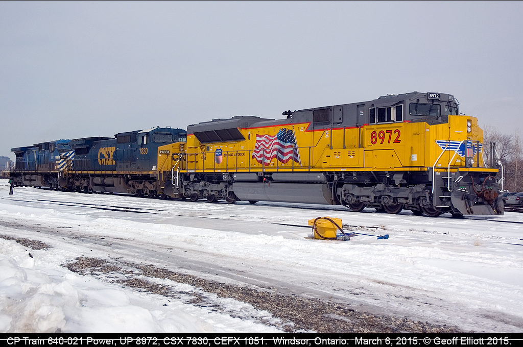 Union Pacific SD70AH #8972 led train 640-021 to Windsor, Ontario on March 6, 2015 with CSX 7830 and CEFX 1051 in tow.  Once it arrived they backed the train into the yard to stage it for a later departure.  Here the power sits waiting for the time that they'll be tied back onto the train to depart.