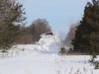 After getting stuck while attempting to run through this drift, 1001 has backed up, uncoupled from its train and, after taking a running start, takes a more aggressive approach to clearing the track.