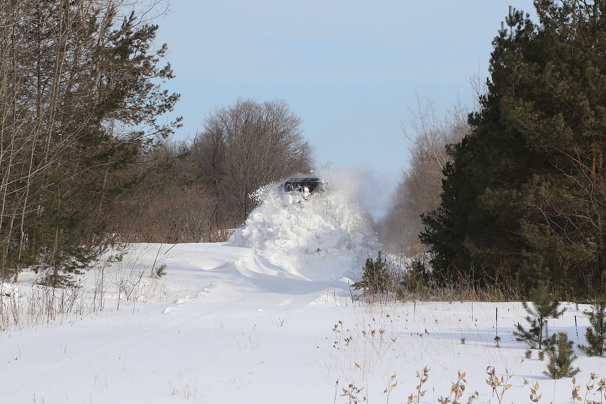 After getting stuck while attempting to run through this drift, 1001 has backed up, uncoupled from its train and, after taking a running start, takes a more aggressive approach to clearing the track.