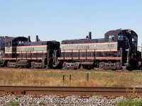 Cando Contracting SW8M 1002 and SW1200 1003 are seen switching the Invista plant coupled nose-to-nose, at Millhaven, Ontario. Invista was fibre manufacturer, formerly KOSA and before that Celanese. Their Millhaven plant, located 10 miles west of Kingston, ceased production in April 2000 and was demolished in 2013.
<br><br>
Invista was located on CN's Millhaven Spur, 1.5 miles in from the Kingston Sub switch at Mile 186.6. CN switched the plant for many years, but Cando was later contracted to do the job. With Invista gone Cando continues to do contract switching for the neighbouring Coco Paving asphalt plant.
<br><br>
According to the CTG, CCGX 1002 was originally built as Lehigh Valley SW8 in September 1951, and CCGX 1003 was originally built for the Pennsylvania Railroad as SW1200 7921. Both were acquired by Cando from dealer Andrew Merrilees in 1996.