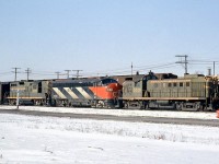 An eastbound Canadian National freight passes through Mimico East on the Oakville Sub, with CN RS3 3019, F7A 9082, and GP9 4560. Only the F7A is in the new "1961 scheme" introduced two years earlier (the cowl unit version of which featured zebra stripes instead of CN noodle logos on the side).
<br><br>
Also note how the leading RS3 and trailing F7A both feature white extra flags.