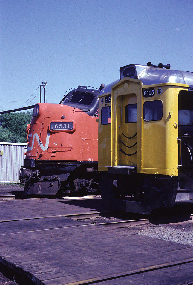 CN FP9A 6531 and Via Rail RDC-1 6105 sit on the outbound tracks at the Fairview roundhouse in the late afternoon on a nice June day. I likely stopped here on my way home from university, they will both move to Ocean Terminal shortly to start their trips.