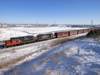An extra 546 pulls out of Oshawa behind CN 107, with cars for Ajax.