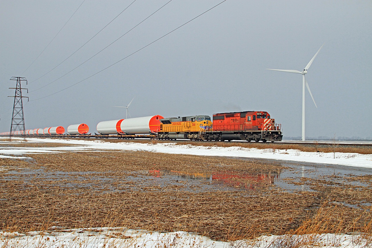 CP 5976 with helper UP 3568 are in charge of eastbound train DIM-003 at mile 88.1 on the CP's Windsor Sub. The towers were constructed in Windsor by CS Wind.