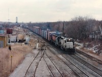 A slightly later than normal NS #327 autoparts train, Buffalo to St. Thomas. Nice to see one of those white KCS units (670-676) that CP bought on the lead. Looking eastward from the Merritt St. bridge power is CP 671, NS 2809 and CP 5526. Tough shot in morning sunshine. The 671 renumbered to CP 5416 in late 1997 and retired 2001. I never did see this unit renumbered and wondered if it actually got painted to CP or not.