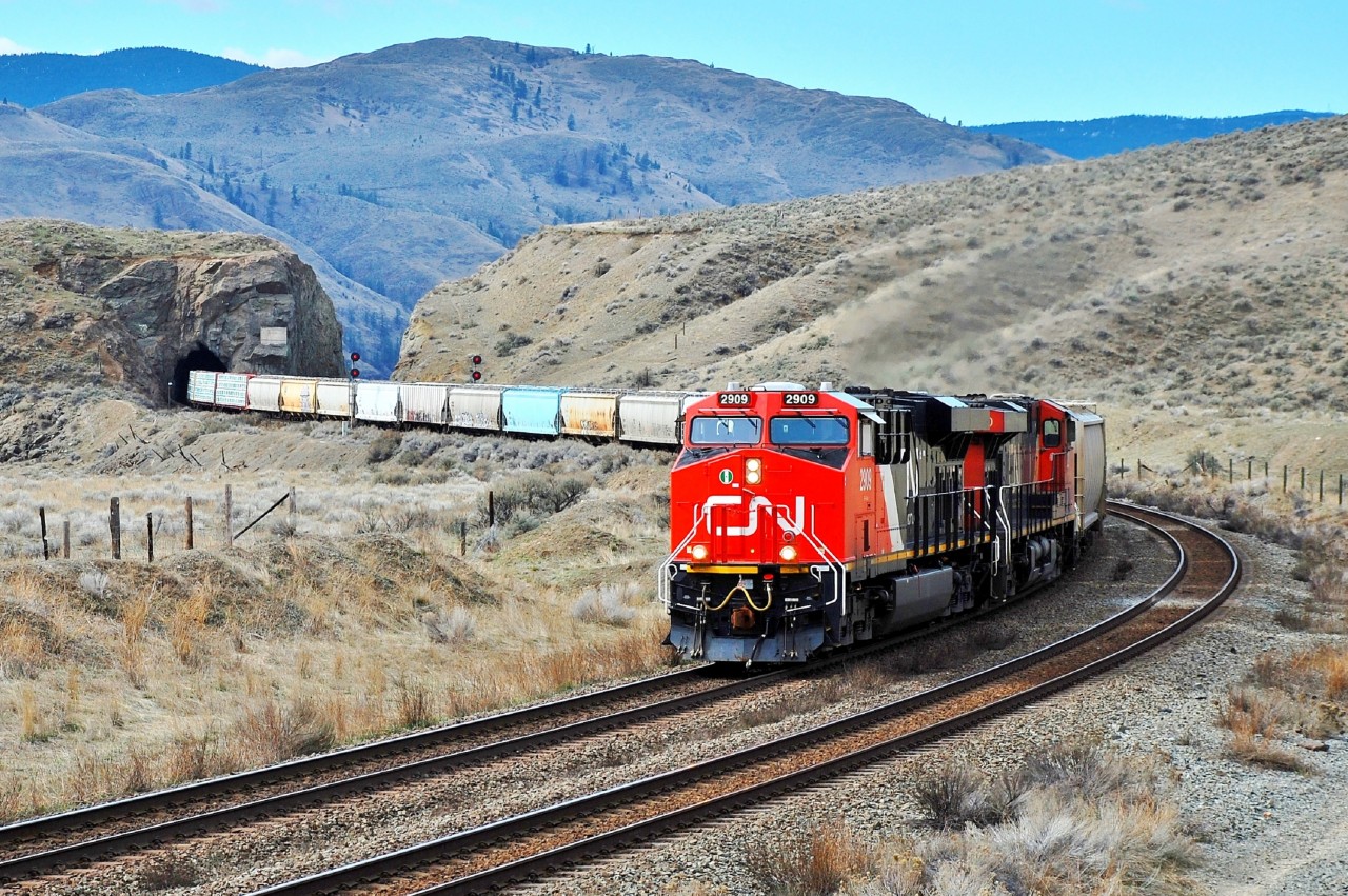 This mixed freight is passing through the tunnel at Kissick behind CN nos.2909 & 2220 and is headed eastwards towards Kamloops.