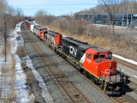 <b>LNG test unit leading an insane lashup.</b> A late CN X324 has a pair of SD40-2W's leading a Dash8 cowl (CN 5258, CN 5287 & CN 2417) as it heads east on CN's Montreal Sub. The lead unit had been converted to run on LNG fuel for test purposes a few years back and acquired SD45-like flares in the process. It has since been converted to regular diesel operation. The two lead units came into Montreal in the wee hours of the morning on CN 372. SD40-2W's have become very rare in the Montreal area, so this was a nice catch.