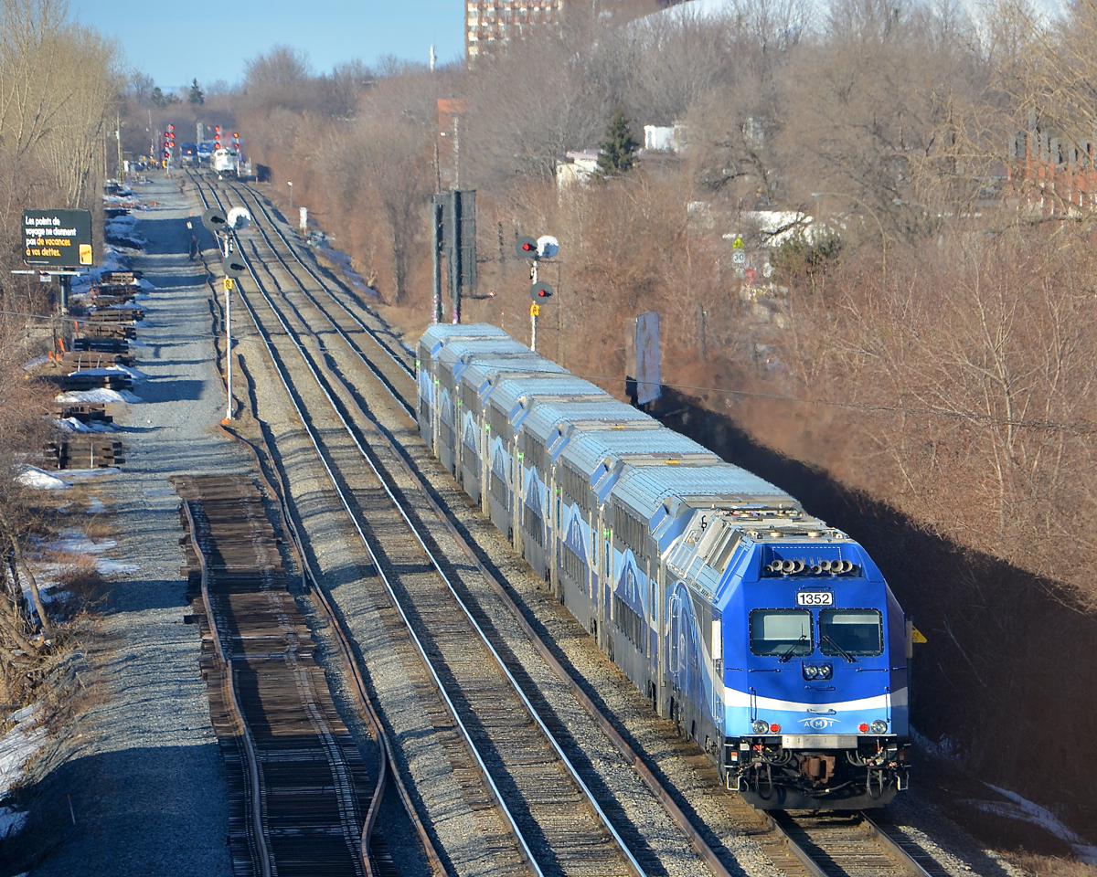 AMT 1352 pushes a deadhead movement west on CP's Westmount sub during the morning rush hour. In the far distance three more AMT trains can be seen near Montreal West station.