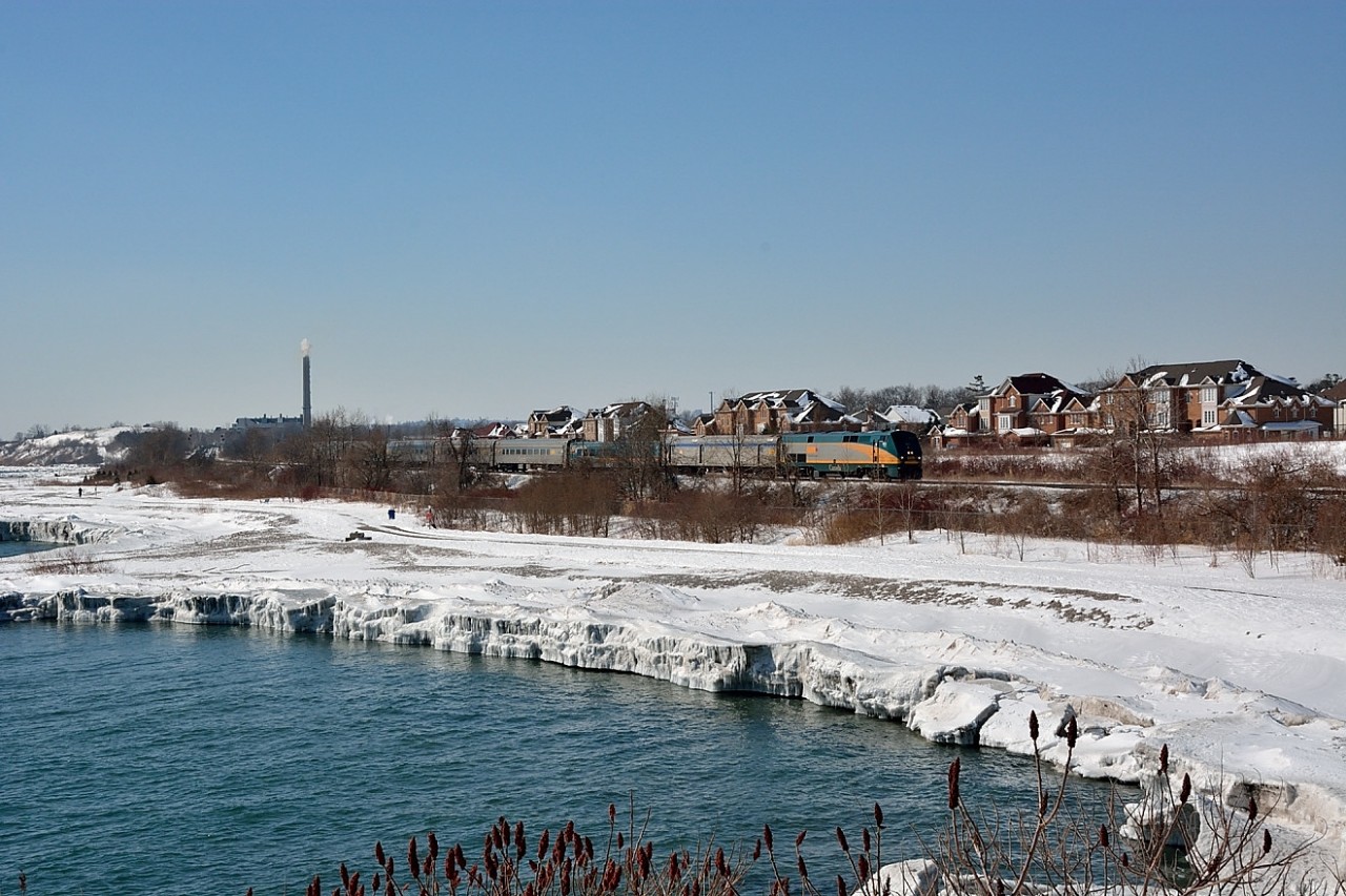 VIA #903 (GE P42DC circa 2001) leads VIA #61 with a mix of LRC(circa 1981-1983)  and stainless steel conventional (circa 1948-1955) equipment  near  CN Kingston Sub mile 318 (west of CN Rouge Hill (formerly CN Port Union)). The VIA 61 passengers have an icy vista of the stoney Lake Ontario shoreline transformed into icy cliffs  due storm wave action throughout the cold 2015 winter months. The cold weather leaves the north shore of Lake Ontario as one of the few remaining stretches of Great Lakes open waters ( Ontario is 82% ice covered (record is 85% in 1979) and Lakes Huron, Superior and Erie are  95% to 98% ice covered). The Seaway has already delayed re-opening, late March 2015 at the earliest so expect the rails to remain busy for a while yet.Feb 28 2015 image by S.Danko