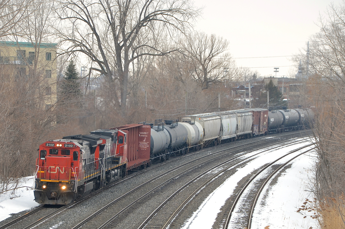 CN 394 for Richmond, Qc and interchange with the St. Lawrence and Atlantic has CN 2102 and CN 2689 as it heads east through the Ville St-Pierre neighbourhood of Montreal.