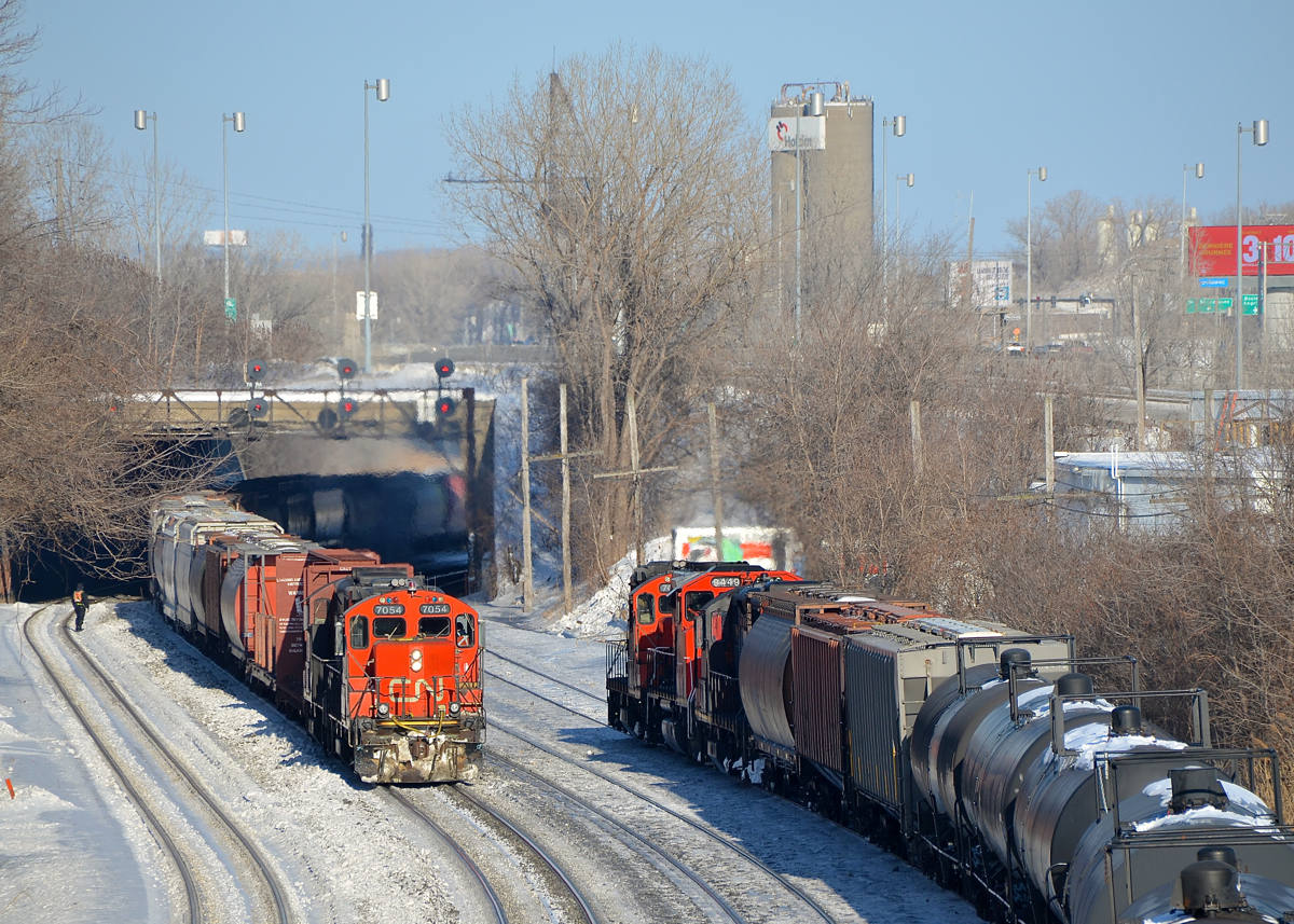 CN 527 with CN 7054 & CN 4102 is passing a stopped CN 586 which has two GP9's and a GP40-2LW.