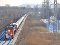 CN 305 heads west through Point-Claire, Qc on Montreal's West Island with a decent amount of snow on the train. It has CN 2325 & CN 2565 and CN 8915 mid-train. 