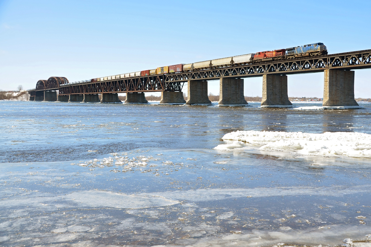 Crossing the frigid St. Lawrence. A fairly long CP 253 has CEFX 1006 & CP 8503 as power as it crosses the frigid St. Lawrence river on its way to the island of Montreal on a very cold morning.