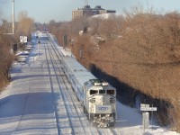 Ex-GO Transit RBRX 18524 pushes an AMT deadhead movement towards Montreal West station during the morning rush hour. The station is in the far distance, and two more AMT trains are visible there. Of note is that the rooftop radiators on the F59PH are still green.
