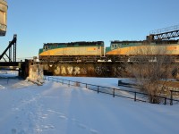 A pair of F40's (VIA 6426 & VIA 6431) lead a slightly late VIA 64 from Toronto over the Lachine Canal, with the CN Wellington tower at left.