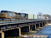 <b>CSX power on CN 327 again.</b> CN 327, the daily train from Montreal to Huntingdon for interchange with CSX once ran with CSX power most of the time, but ran with CN power for much of 2014. However CSX power is now seen a bit more often on this train. Here CN 327 with CSXT 119 and CSXT 328 crosses the Ottawa River as it leaves Montreal behind.