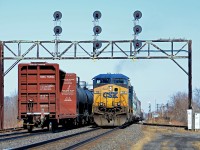 CN 327 with CSXT 119 and CSXT 328 is backing up on the Kingston sub so that it can head south on the Valleyfield sub (seen at right). Passing at left is CN 368.