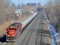 CN 705 has two of CN's secondhand units (CN 5433 & CN 2192) as well as some loaded TankTrain cars (destined for Maitland, ON) ahead of the oil empties. Here it heads west through Lachine.