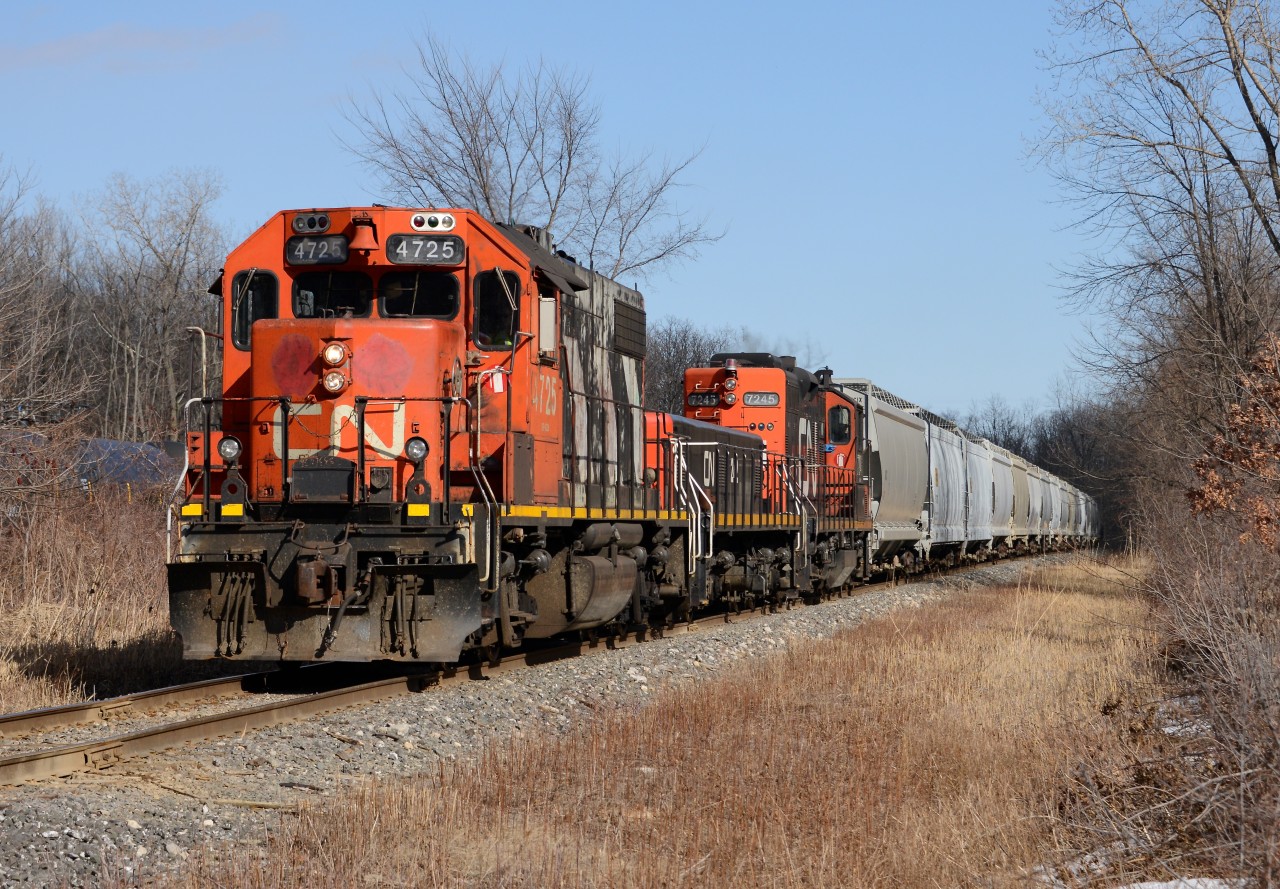 CN 4725 crosses Degurse Dr. with a cut of cars on the Industrial Sub south of Sarnia.