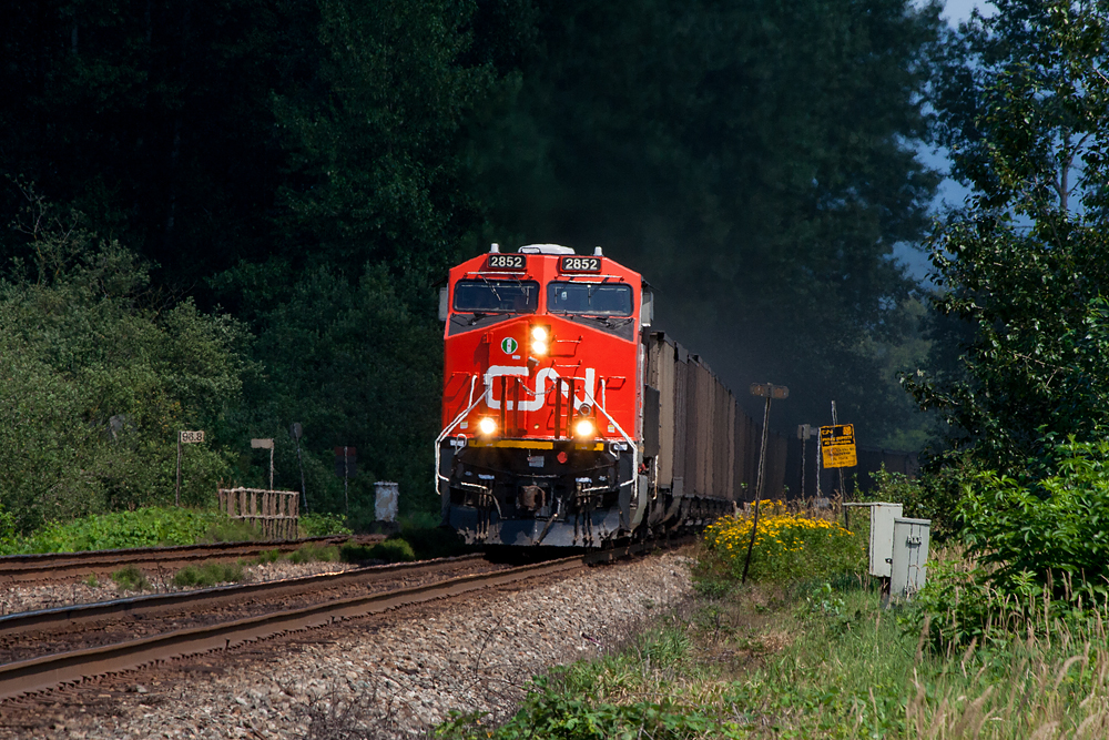 Its a cloudy day, you are out trackside and the sun is playing cat and mouse with a sucker hole. You know your targeted subject is on its way and at the right moment, the magic happens. On this day CN 2852 shows up in time, as it blasts out of a dark area and into the sunlight, on its way west to Roberts Bank, with a coal train in tow.