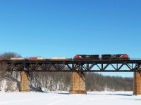 148 crosses a frozen Grand River hauled by CN 8917 and 2549. There were a lot of empty flats on this train.