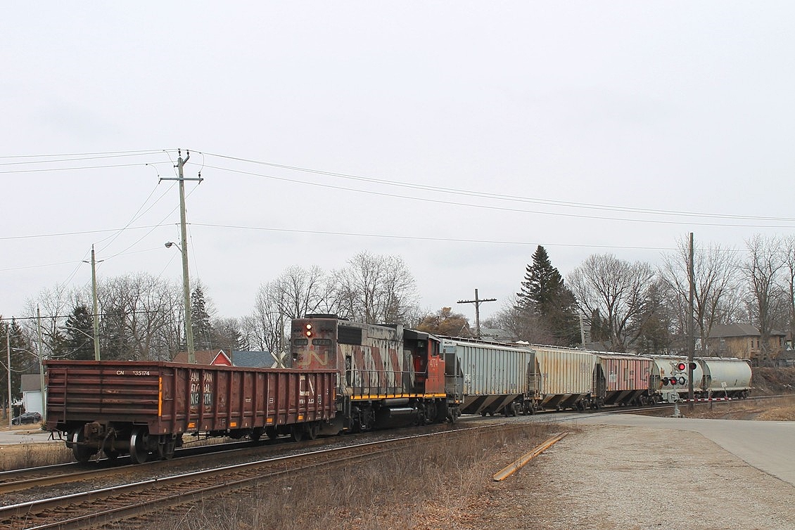 CN Distributed power or just weird? CN 4774 arrives with a gondola at the front and hoppers to the rear. I don't know where they were going to leave them, as the North service track was completely full with tank cars?