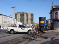 After completing their work at Ingenia, SOR 496 is seen shoving back up the Burford Spur with RLK 4003 and 4 hoppers.  They have just cleared Colborne Street and traffic is able to resume as they head back towards the Dundas Subdivision.