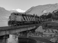 The daily CN Squamish Switcher is seen passing along the Howe Sound of the Sea to Sky highway, passing the historic mining town of Britannia, BC. On this morning CN SD60F 5523 and two other EMD work horses are tasked with hauling this train, which is returning southbound back to North Vancouver. 

Its turning out to be a nice day, however by the time the train came along, the sun hadnt quite reached around to our chosen spot, thus the black and white treatment, which Im quite happy with. 