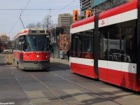 Old meets new, one of the newly acquired Flexity Outlook streetcars is operating on the 510 Spadina Route - the only route that meets the sufficient needs of these streetcars. By 2019, all 11 of Toronto Transit Commission's streetcar routes will have these new streetcars in operation.  