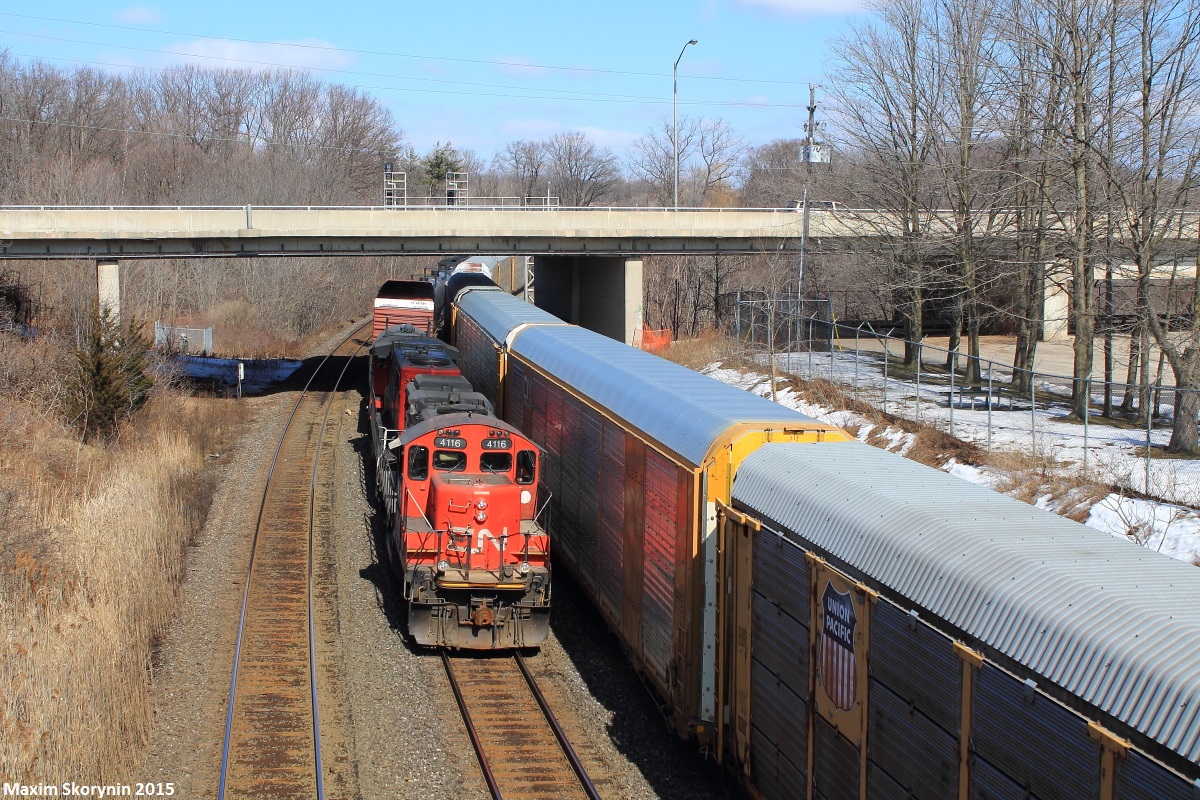 CN GP9RM 4116 is on point of this days 551 which moves cars from Aldershot Yard in Aldershot to Hamilton Yard in Hamilton daily. It is seen here passing by a pedestrian bridge leading to Royal Botanical Gardens on the approach to CN Bayview Junction between the Oakville, Grimsby and Dundas Subdivisions.