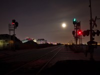 Armageddon? Nah, its just a full moon with light cloud cover in front of it. Meanwhile, CN 330 is lined up on the south main with a clear signal displayed at Third Street Louth. 
