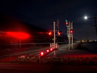 CN 330 knocks out the south track signal at Third Street Louth in St. Catharines. About 400000 kilometers away, a full moon watches over Earth. 