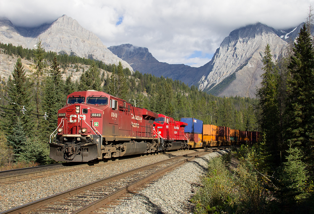 On a nice sunny afternoon, a CP priority stack train heads west through Leanchoil, as Mount Chancellor stands tall in the background.
