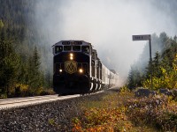 Those EMD turbochargers in full swing, the Rocky Mountaineer heads eastward through the former station name sign of Hector, after pulling up the Big Hill. We had chased the train on the east side of Palliser in the Kicking Horse Canyon and all the way the billow of smoke was non-stop. 