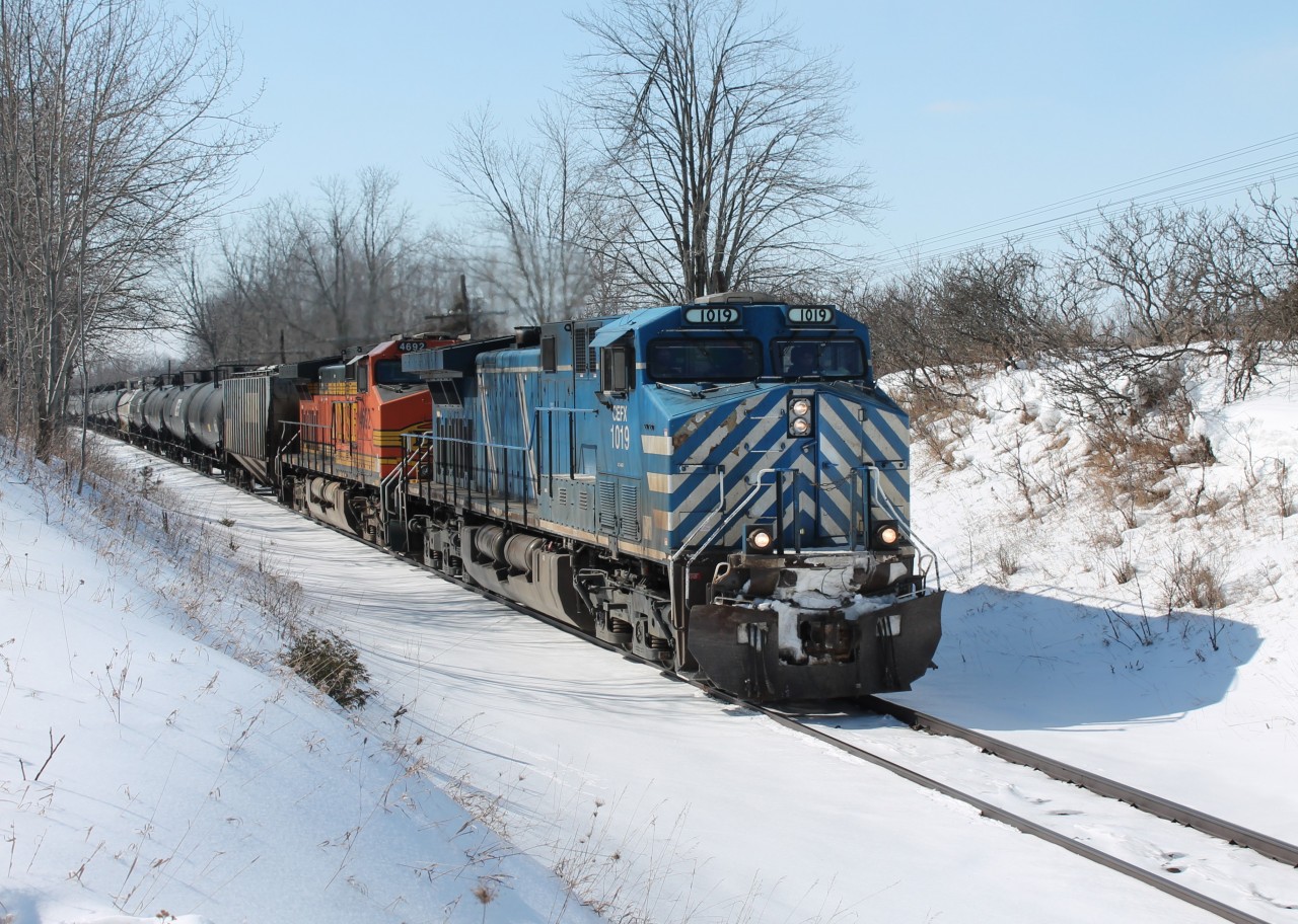 CEFX 1019 leads BNSF 4692 through Puslinch on a cold day after freezing rain put a layer of ice over all the snow.